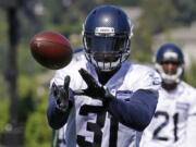 Seattle Seahawks strong safety Kam Chancellor catches the ball during an NFL football training camp, Monday, July 31, 2017, in Renton, Wash. (AP Photo/Ted S.