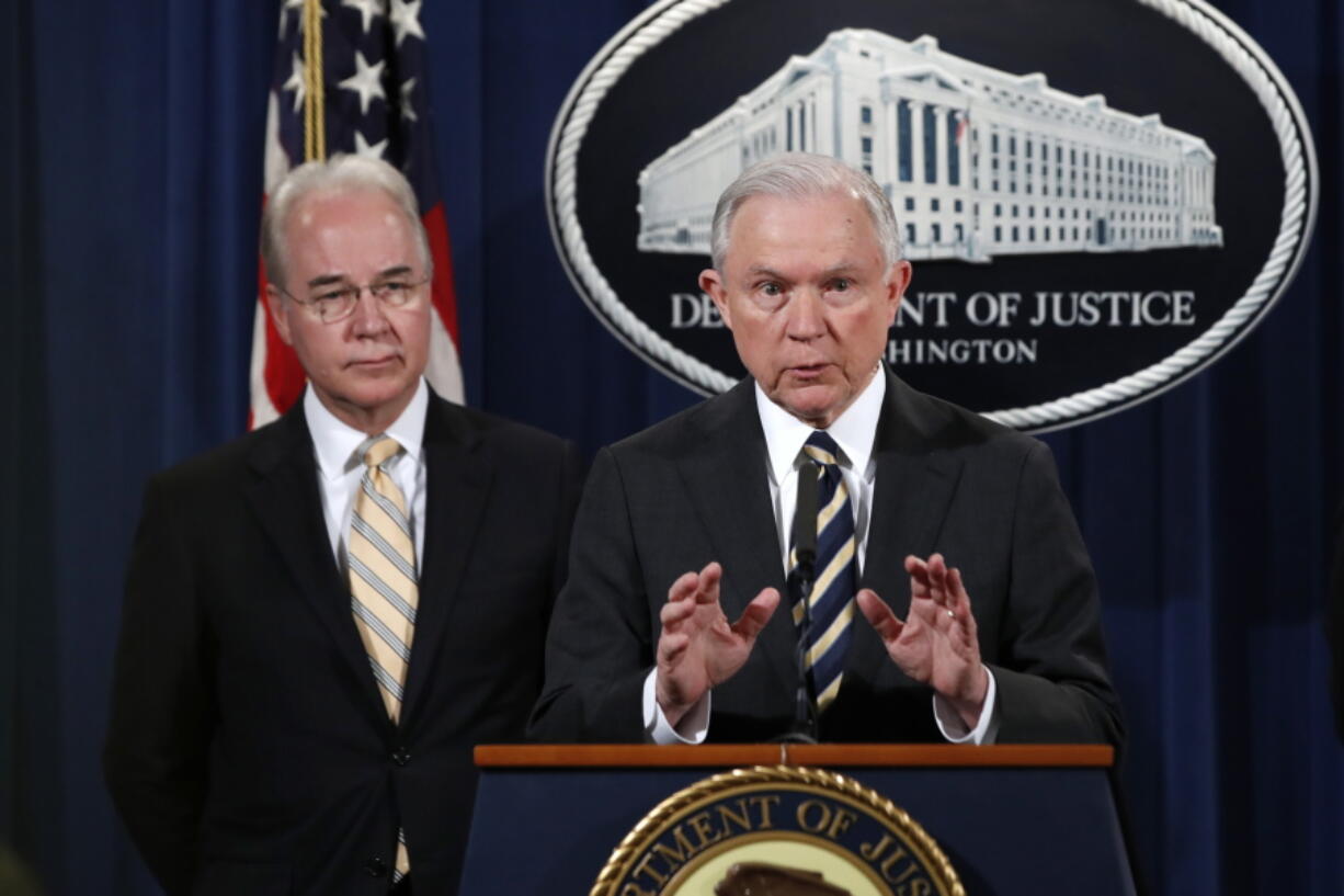 Attorney General Jeff Sessions, right, with Health and Human Services Secretary Tom Price, speaks about opioid addiction during a news conference Thursday at the Justice Department in Washington.