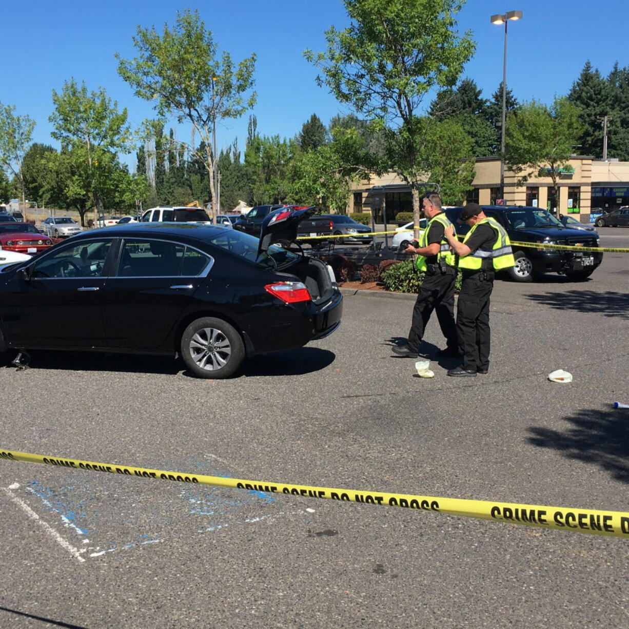 Clark County sheriff's deputies inspect a Honda Accord that struck three pedestrians Saturday.