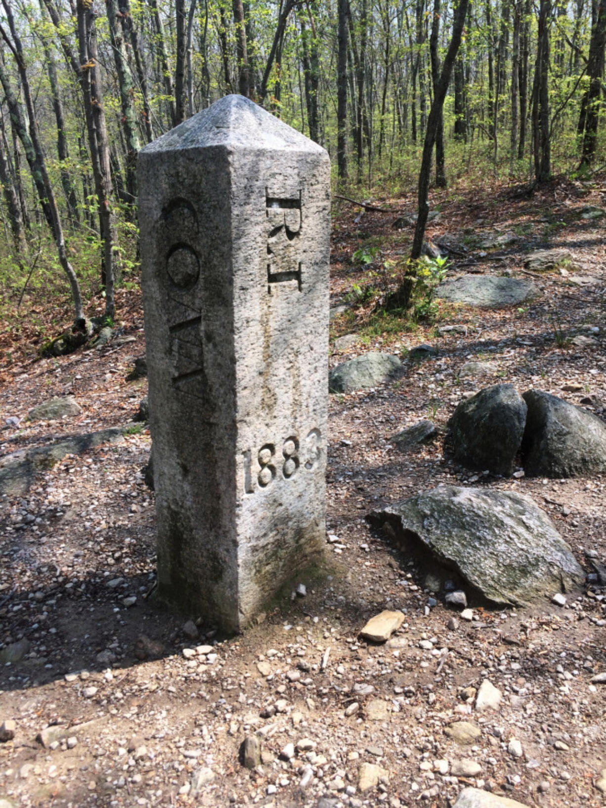 The granite monument that marks the spot where Connecticut, Massachusetts and Rhode Island meet in Thompson, Conn. There’s an unusual travel hobby that has people visiting the woods of Thompson, and other remote spots across the country. The visitors are looking for tripoints, spots where three states meet.