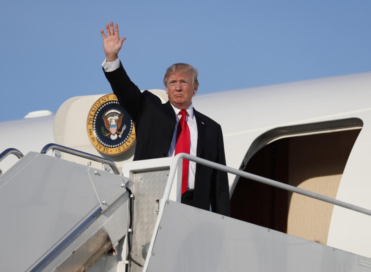 President Donald Trump boards Air Force One at Morristown Municipal Airport in Morristown, N.J., Monday, en route to Washington from Trump National Golf Club in Bedminster, N.J.