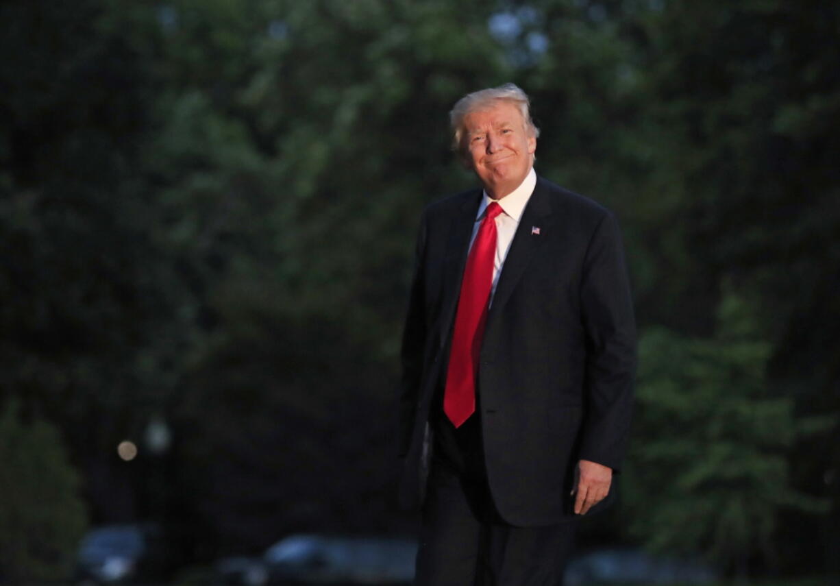 President Donald Trump smiles as he walks on the South Lawn upon arrival the White House in Washington, on Saturday from the G20 Summit in Hamburg, Germany.