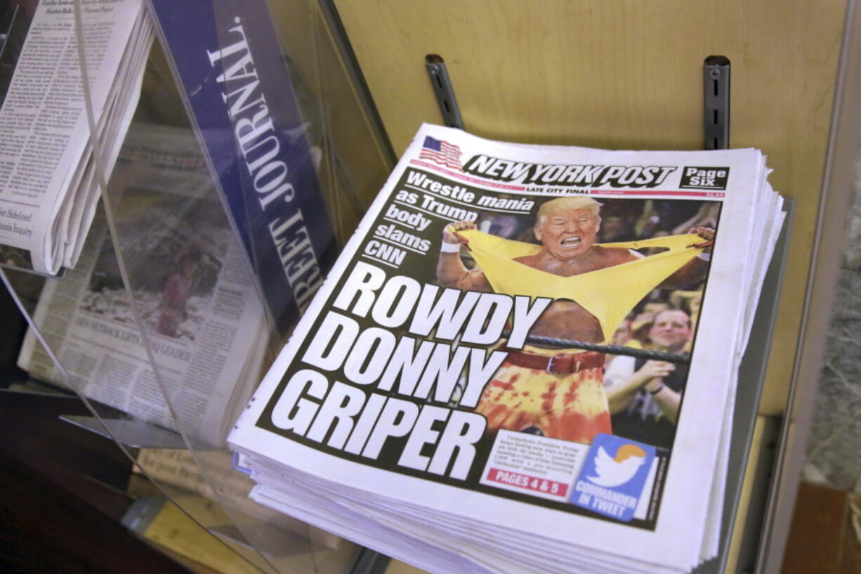 Copies of the New York Post with an illustration of President Donald Trump as a professional wrestler on the front page are displayed at a newsstand in New York City on Monday. On Sunday, Trump’s apparent fondness for wrestling emerged in a tweeted mock video that shows him pummeling a man in a business suit with his face obscured by the CNN logo.