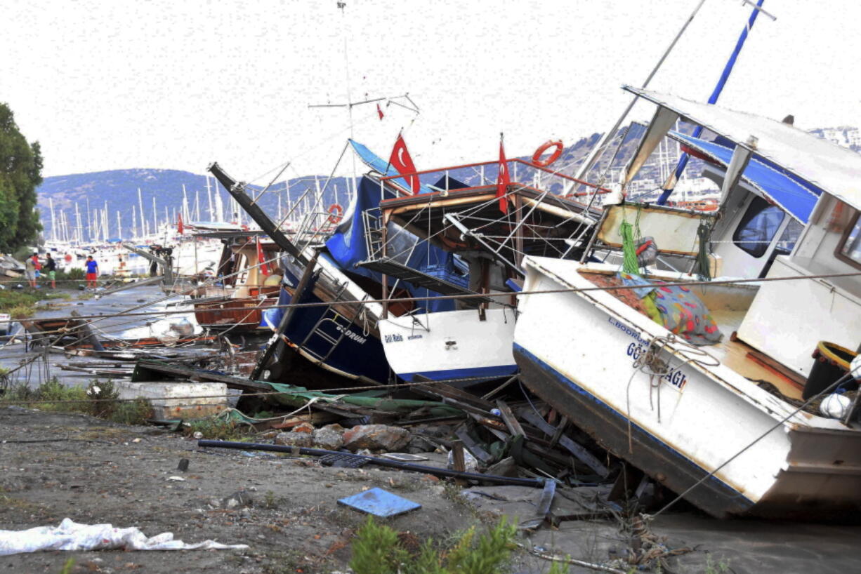 Boats that crashed on top of each other in the harbor in Bodrum, Turkey, in the overnight earthquake are seen, Friday, July 21, 2017. A powerful earthquake sent a building crashing down on tourists at a bar on the Greek holiday island of Kos and struck panic on the nearby shores of Turkey early Friday, killing people and injuring some 200 people.