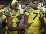 Oregon wide receiver Darren Carrington, left, dismissed from the Ducks two weeks ago soon after he was arrested on a misdemeanor charge of driving under the influence, has signed with Utah.