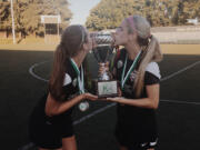 Washington Timbers Brenna Bogle and Abby Bohn kiss the Northwest Premier League Championship trophy after beating Seattle 2-1 on Sunday, July 30, 2017 at Tukwila.