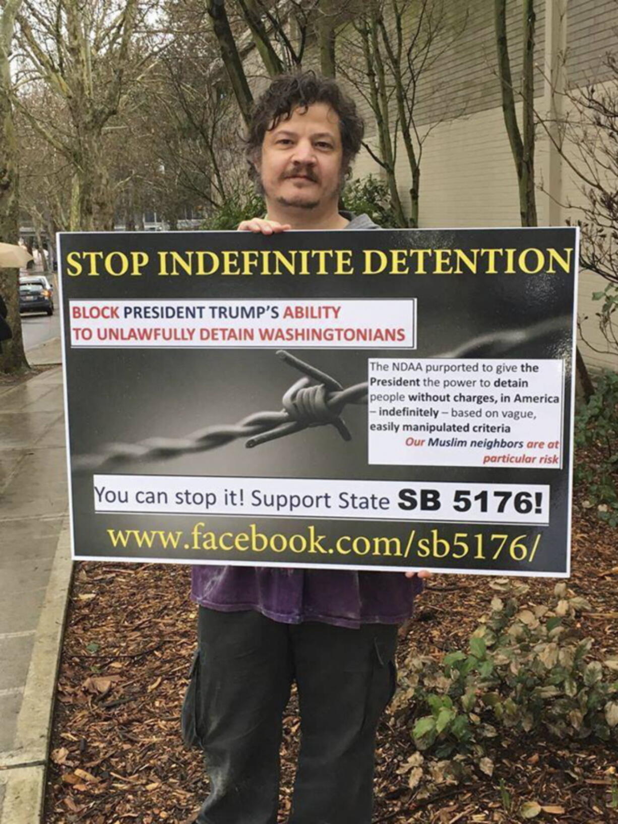 Richard L. Rynearson III, of Bainbridge Island, demonstrates in favor of legislation in Seattle.