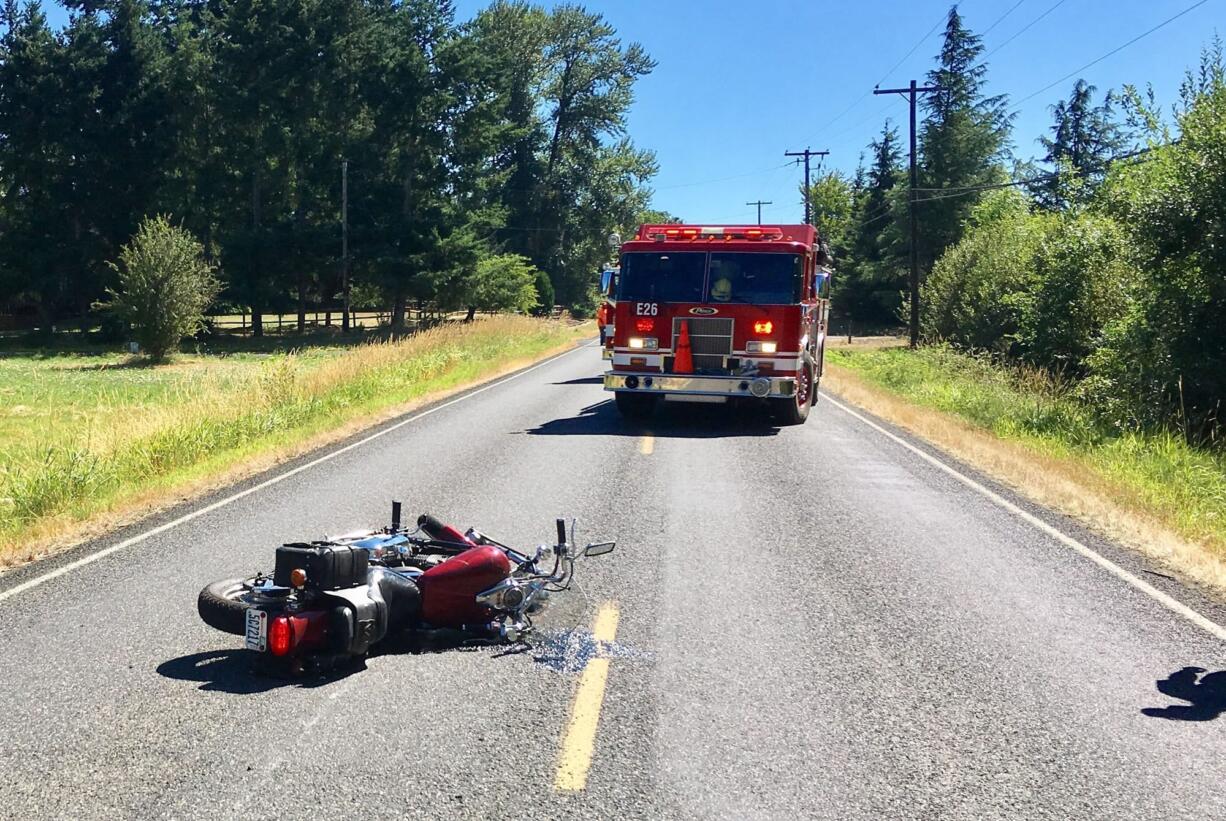 A motorcycle lays on Northeast 179th Street near Northeast 53rd Avenue northeast of Salmon Creek where a man veered to avoid a deer and tipped over, sliding into the deer. The man was taken to a hospital to be treated for injuries sustained in the collision. The deer reportedly limped off and ran away.