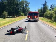 A motorcycle lays on Northeast 179th Street near Northeast 53rd Avenue northeast of Salmon Creek where a man veered to avoid a deer and tipped over, sliding into the deer. The man was taken to a hospital to be treated for injuries sustained in the collision. The deer reportedly limped off and ran away.