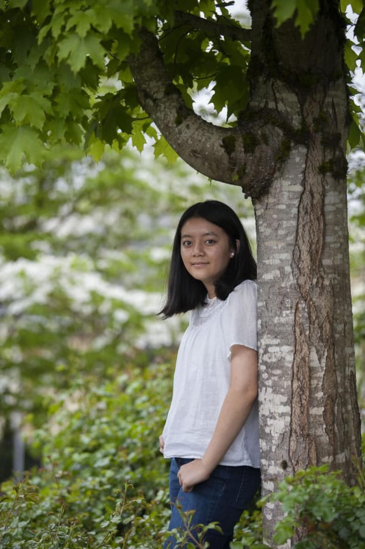 Camas High School sophomore Tsering Shola, 16, pictured at Camas Public Library on May 11, has overcome hearing challenges to succeed.