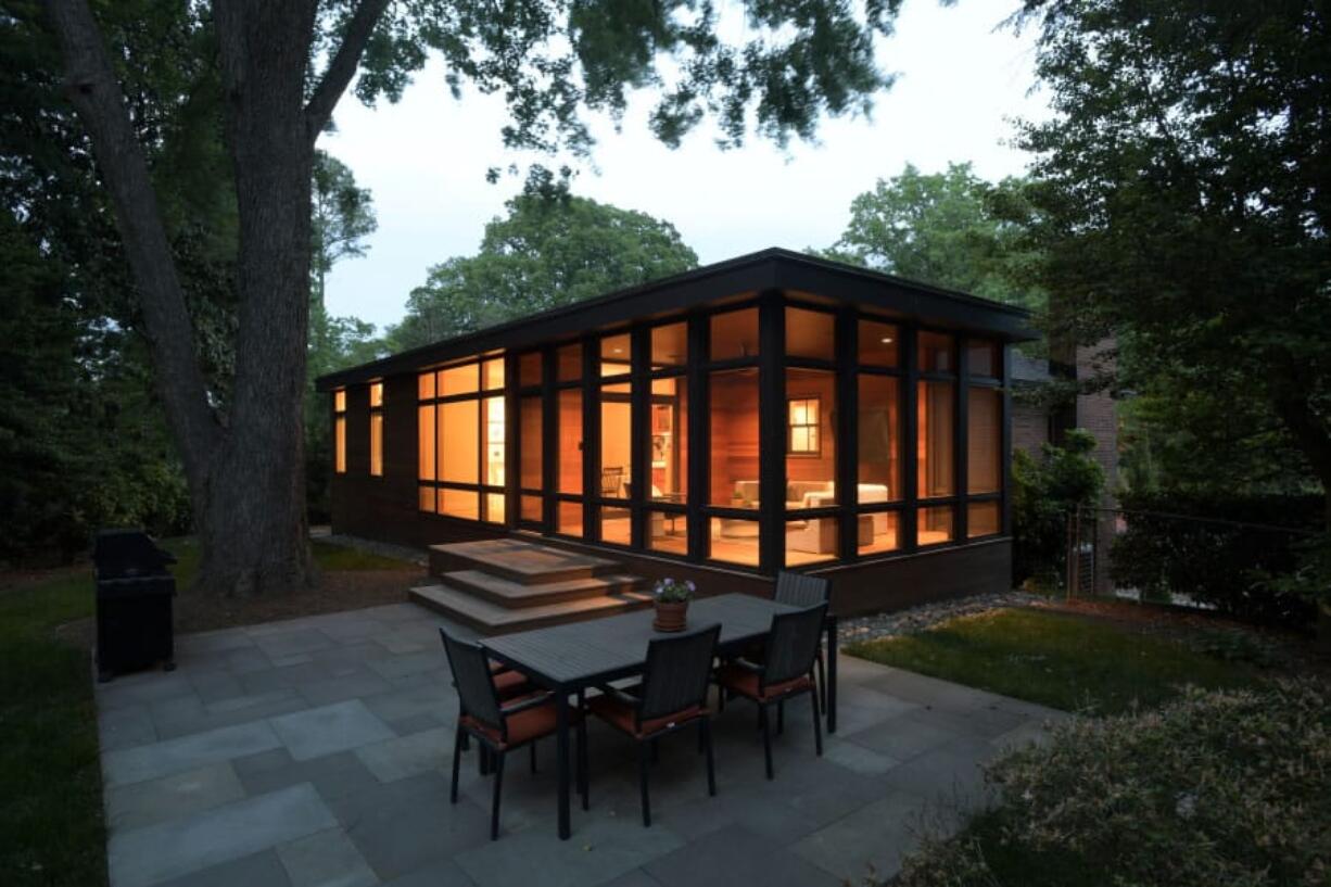 The added-on porch is treated as a room well blended into the new wing of the Sicuranza’s Washington-area house.