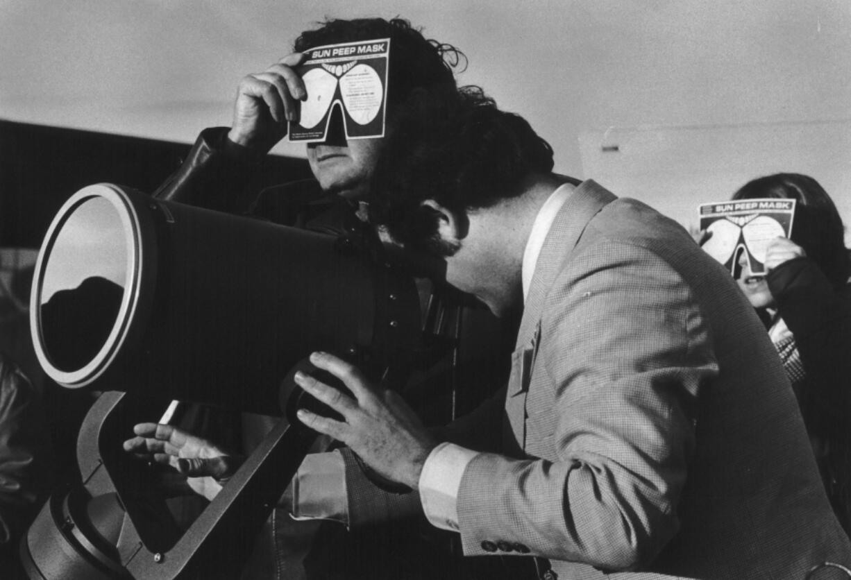 William Yantis, director of Goldendale Observatory, peers into a Celestron telescope in a photo taken by Jim Vincent as the path of a total solar eclipse passes over Klickitat County on Feb. 26, 1979.