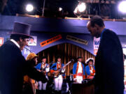 Burgess Meredith, left, as the Penguin, and Vancouver’s Roger Hart, manager of Paul Revere and the Raiders, when the band filmed an episode of “Batman.” Contributed photo