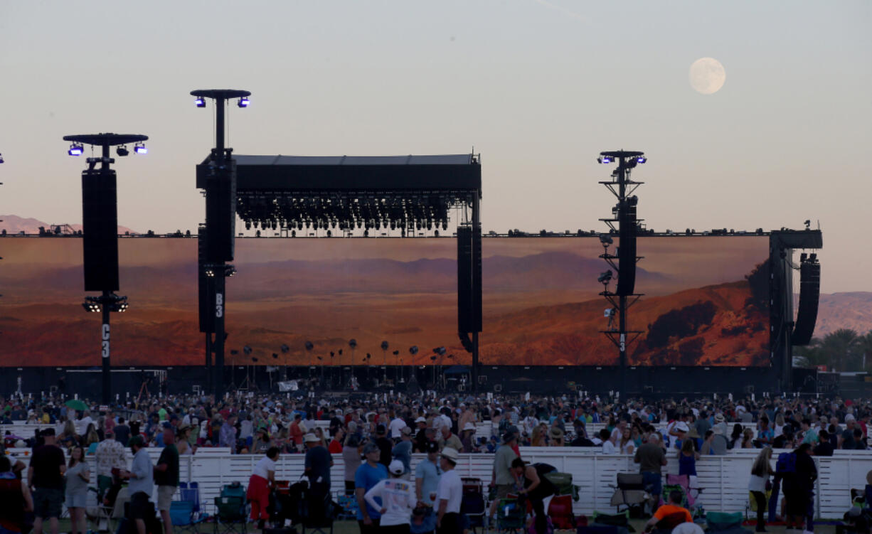 The moon rises over the stage as music fans wait for Bob Dylan to perform at the Empire Polo Grounds on the second weekend of Desert Trip in Indio, Calif., on Oct. 14, 2016.