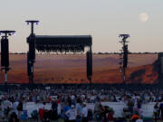 The moon rises over the stage as music fans wait for Bob Dylan to perform at the Empire Polo Grounds on the second weekend of Desert Trip in Indio, Calif., on Oct. 14, 2016.