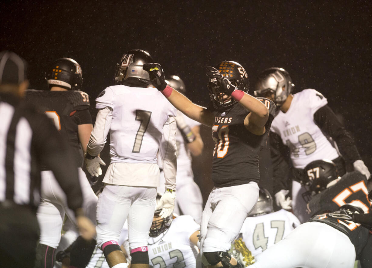 Battle Ground's Noah Barr (50) celebrates after a touchdown in the first quarter at Battle Ground High School on Friday night, Oct. 7, 2016.