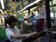 Rejeana Stallings of Vancouver films James Powers Trio as the band plays live jazz on a Vine bus while driving along the Fourth Plain corridor in Vancouver on Friday evening.