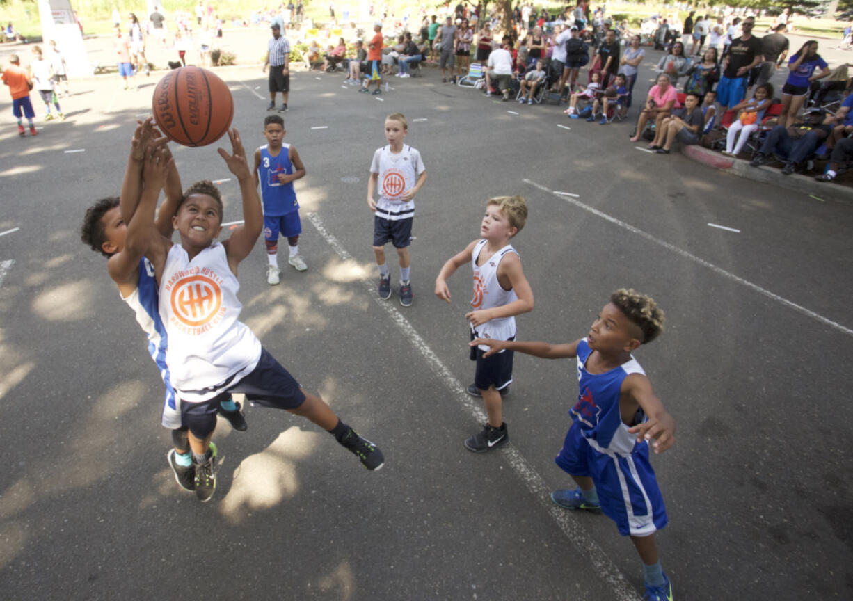 Savion McCoy reaches for a rebound in the 3rd grade division at the Hoops 360 3 on 3 outdoor basketball tournament featuring teams in grades 3-high school plus adult teams.