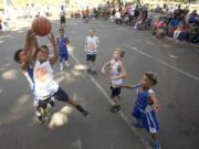 Savion McCoy reaches for a rebound in the 3rd grade division at the Hoops 360 3 on 3 outdoor basketball tournament featuring teams in grades 3-high school plus adult teams.