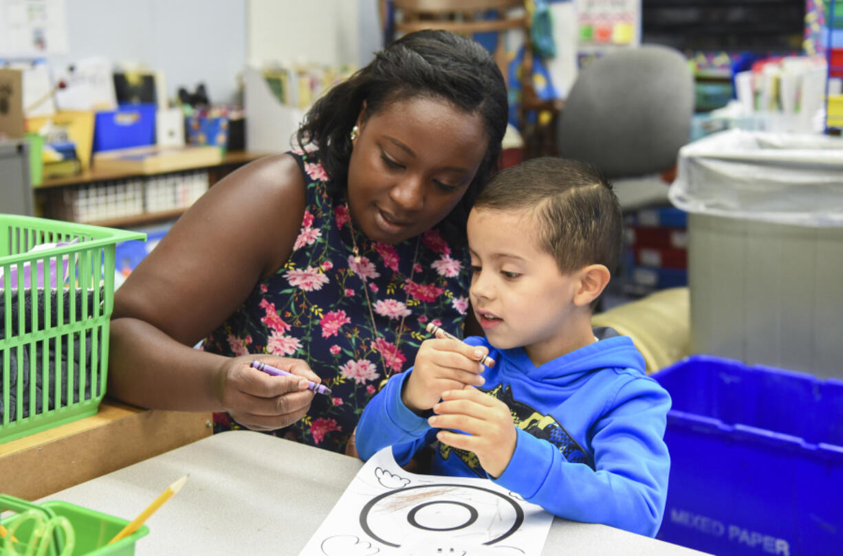 Kindergarten teacher Melissa Bergmann shows Kindergarten Jump Start student Yael Bernat Avila Estrada how to properly hold a crayon during an art project where students learned about the letter “O” at Martin Luther King Elementary School in Vancouver on Monday morning. Through the Vancouver Public Schools Jump Start program, incoming kindergartners get a taste of what their first year of school will be like, including playing with new friends, learning letters and practicing lining up for recess.