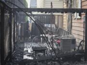 Burned patios at homes on Northeast 130th Avenue are pictured following a fire at Madison Park Apartments in Vancouver, which damaged multiple apartments and nearby homes, Thursday August 3, 2017.