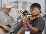 David Tormala fiddles during the Washington Old Time Fiddlers’ Association’s Washington State Fiddle Championships at the Clark County Fair Sunday. David competed in the junior-junior category, for kids 9-12 years old.