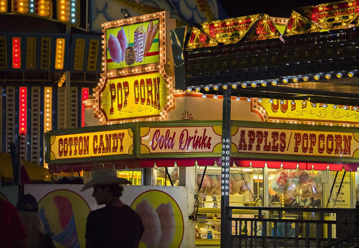 Cowboy hats were in style after the conclusion of the rodeo as bright lights and fair food tempt the crowd at the Clark County Fair in Ridgefield on Tuesday evening.