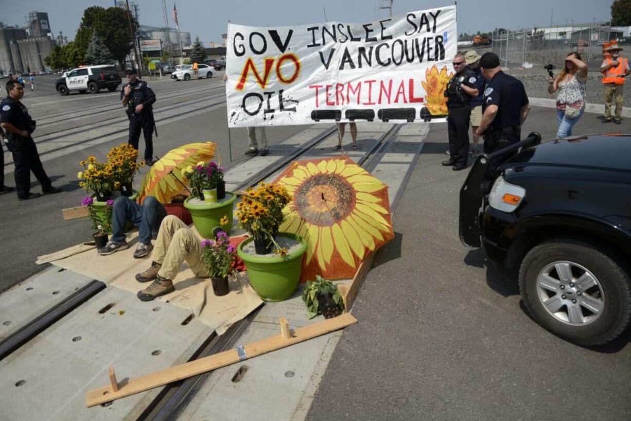 Anti-fossil fuel protesters block BNSF Railway tracks in Vancouver to demonstrate against the Vancouver Energy oil terminal around noon on Monday.