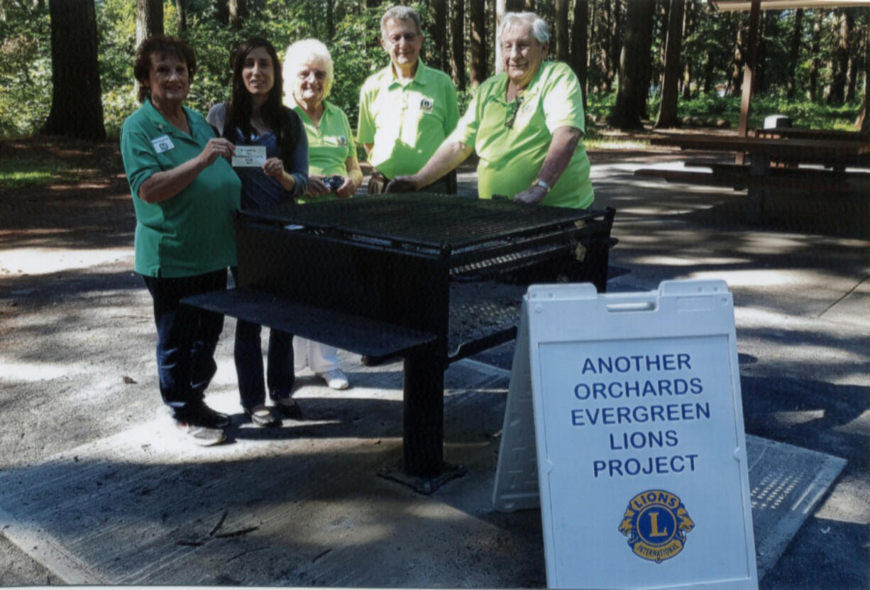 Orchards: Orchard’s Evergreen Lions Club Chairwoman Rosann Grzesiowski, from left, presents a plaque and barbecue to Karen Llewellyn, volunteer coordinator for the Clark County Public Works’ parks vision, along with Mary Jarson, secretary for the Lions, Jim Terrell, past president, and Jack Robbins, president.