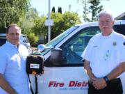 Battle Ground: Battle Ground Public Schools Superintendent Mark Ross, left, and Clark County Fire District 3 Chief Steve Wrightson show the Automated External Defibrillator donated to the district by the fire district and American Medical Response.