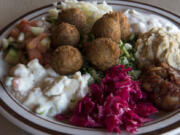 The vegetarian mazza platter with hummus, tabouli, falafel, Mediterranean salad, Turkish salad, tahini, and more is pictured at Jerusalem Cafe.