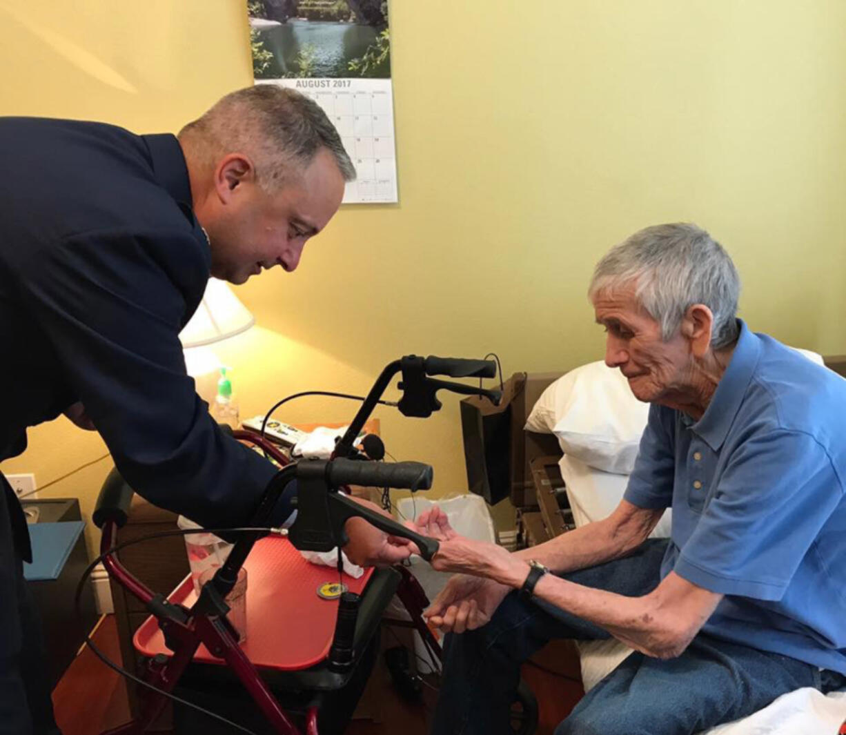 Retired Lt. Col. Andy LaFrazia, left, presents an Air Force challenge coin to Lawrence Silk.