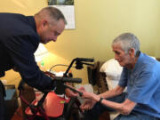 Retired Lt. Col. Andy LaFrazia, left, presents an Air Force challenge coin to Lawrence Silk.