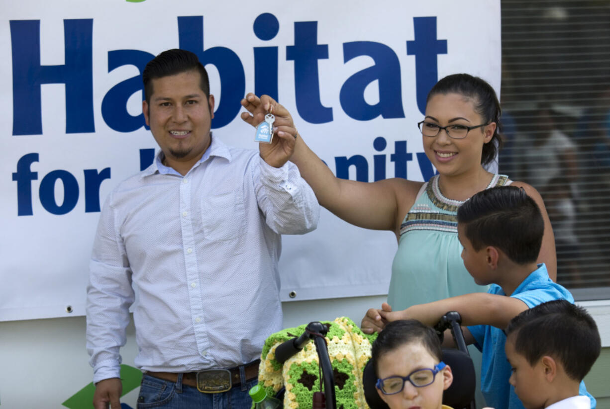 Tino and Soreya Beltran show off the keys to their new home in Vancouver.