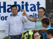 Tino and Soreya Beltran show off the keys to their new home in Vancouver.