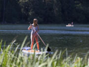 Olivia Van Natta from Bellingham paddles on her board Friday at Battle Ground Lake State Park.