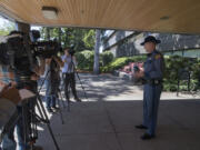 Trooper Will Finn, right, speaks to members of the media outside Washington State Patrol headquarters in Vancouver on Friday about the two crashes this year when victims were not found immediately by the State Patrol.