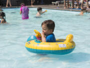 Matteo Gibson, 1, swims around in an inner tube Aug. 28 at the Lake Shore Athletic Club in Vancouver. The National Weather Service says hot temperatures will return to Clark County for the long Labor Day weekend.