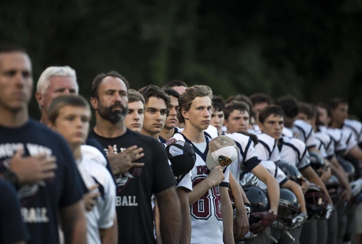 King's Way lines up for the National Anthem before the season opener against Fort Vancouver at Kiggins Bowl on Thursday evening, Aug. 31, 2017.