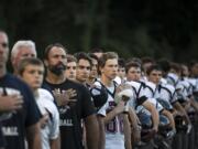 King's Way lines up for the National Anthem before the season opener against Fort Vancouver at Kiggins Bowl on Thursday evening, Aug. 31, 2017.