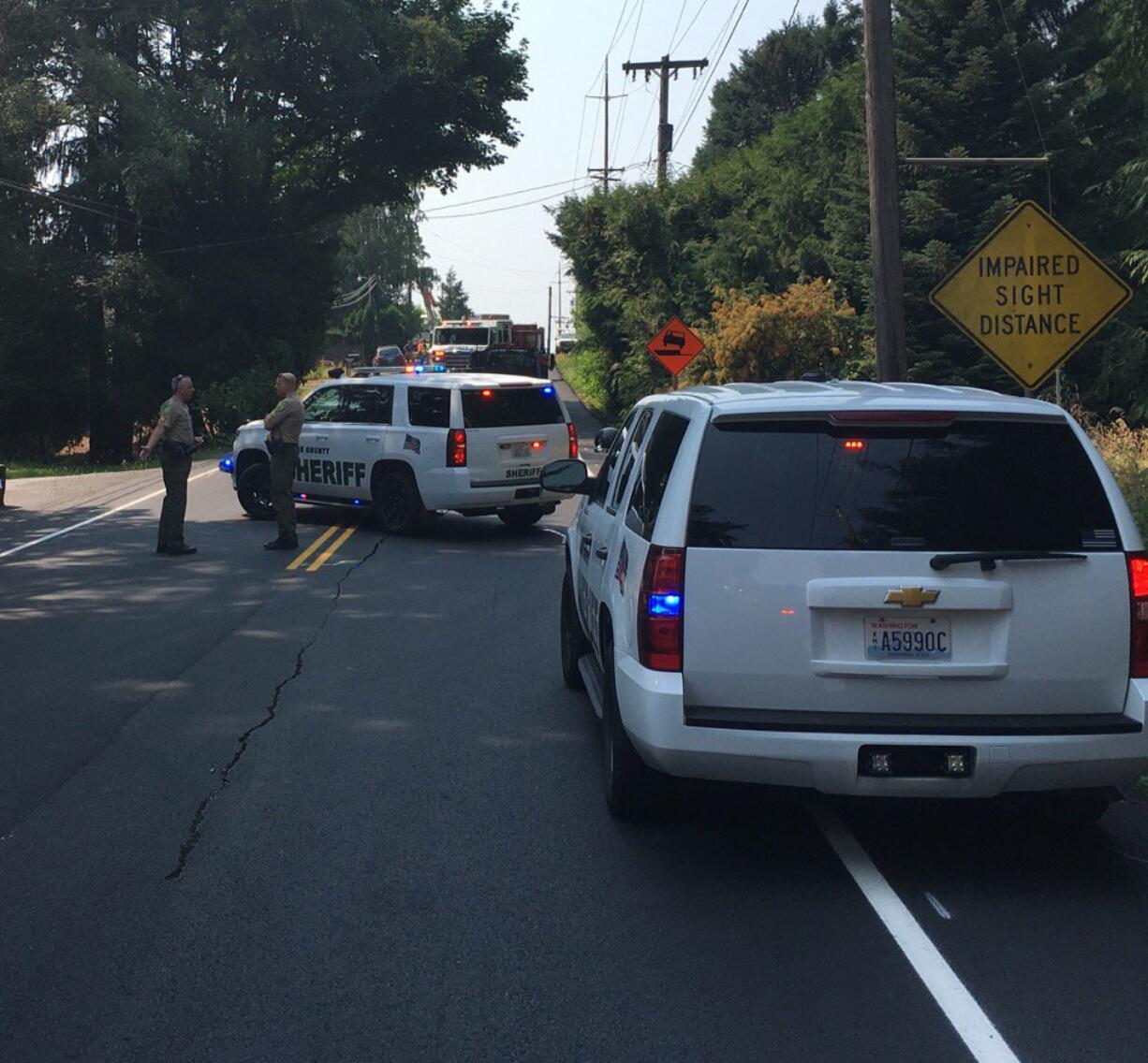 Deputies and work crews block part of Northeast 68th Street in Hazel Dell after a water main burst Monday afternoon.