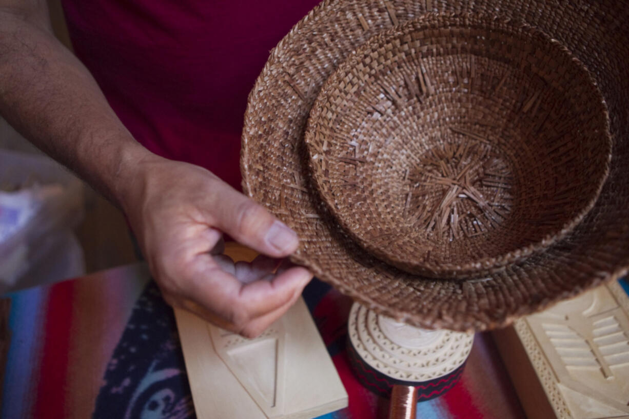 Greg Archuleta, of the Confederated Tribes of Grand Ronde shows a traditional hat he wove of western red cedar bark at the Cathlapotle Plankhouse.