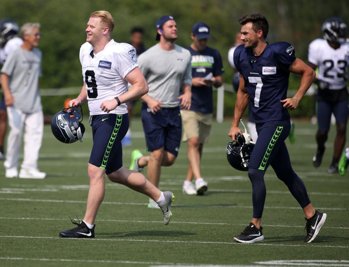 Seattle Seahawks punter Jon Ryan (9) and kicker Blair Walsh (7) take to the field for NFL football training camp, Thursday, Aug. 3, 2017, in Renton, Wash.