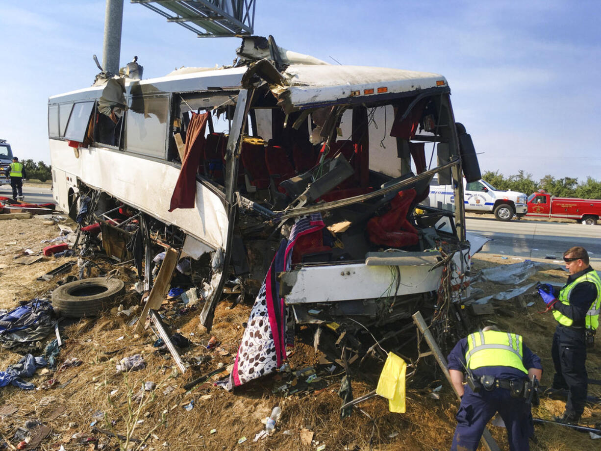 FILE - In this Aug. 2, 2016, file photo, authorities investigate the scene of a charter bus crash on northbound Highway 99 between Atwater and Livingston, Calif. U.S. officials are abandoning plans to require sleep apnea screening for truck drivers and train engineers, a decision that safety experts say puts millions of lives at risk.