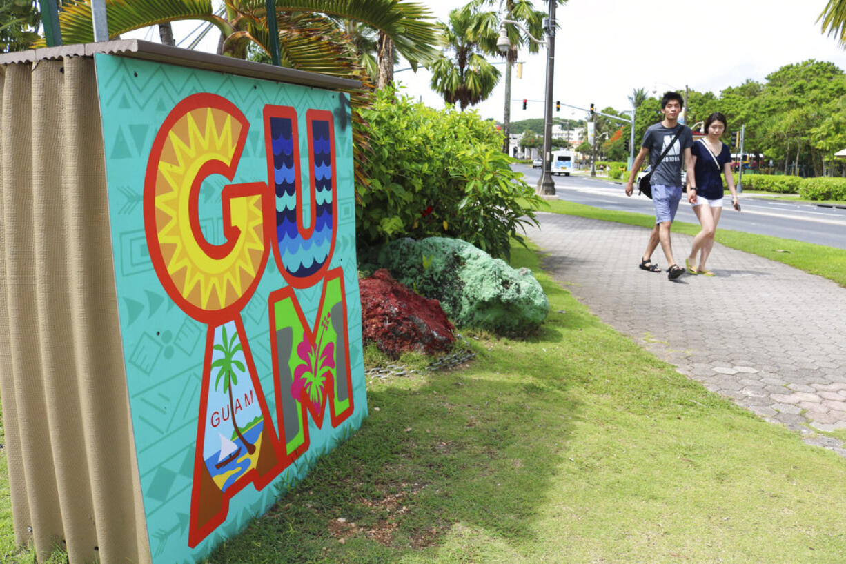 In this May 15, 2017, file photo, tourists walk through a shopping district in Tamuning, Guam. Security and defense officials on Guam said on Aug. 9, 2017, that there is no imminent threat to people there or in the Northern Mariana Islands after North Korea said it was examining its operational plans for attack.