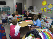 In this photo taken Aug. 8, 2017, Kelsey Nellis, second from right, instructs employees in preparation for the start of the school year at the Mountain View Christian Schools in Las Vegas. More than a third of U.S. states have created school voucher programs that bypass thorny constitutional and political issues by turning them over to non-profits that rely primarily on businesses to fund them. But the programs are raising questions about transparency and accountability at a time when supporters are urging that it be expanded into a federal program.