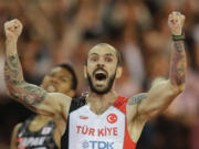 Turkey's Ramil Guliyev crosses the line to win gold in the men's 200-meter final during the World Athletics Championships in London Thursday, Aug. 10, 2017.