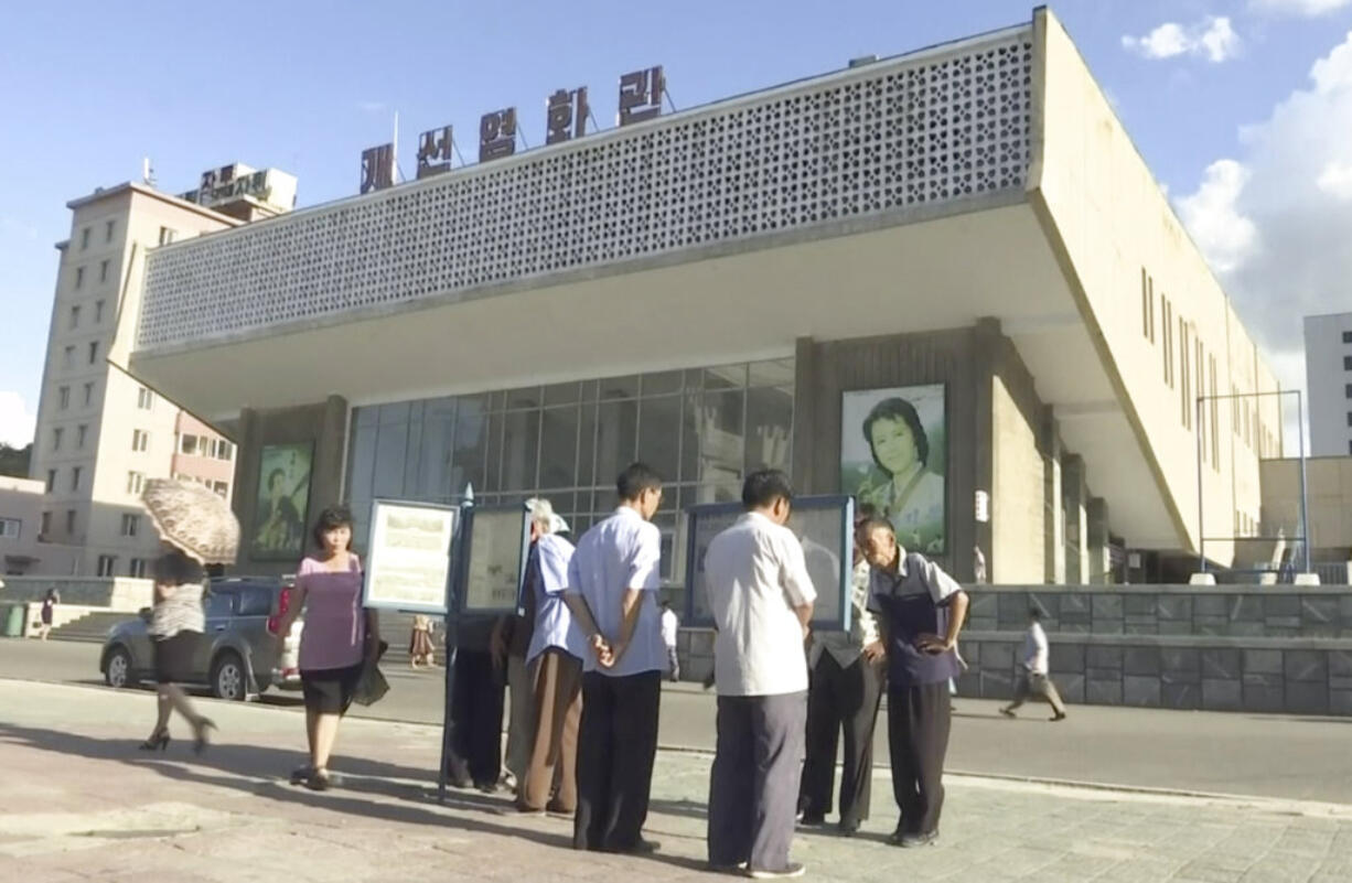 In this image made from video, people read newspapers displayed on the street in Pyongyang, North Korea, Friday, Aug. 11, 2017. Despite tensions and talk of war, life on the streets of the North Korean capital Pyongyang remained calm.