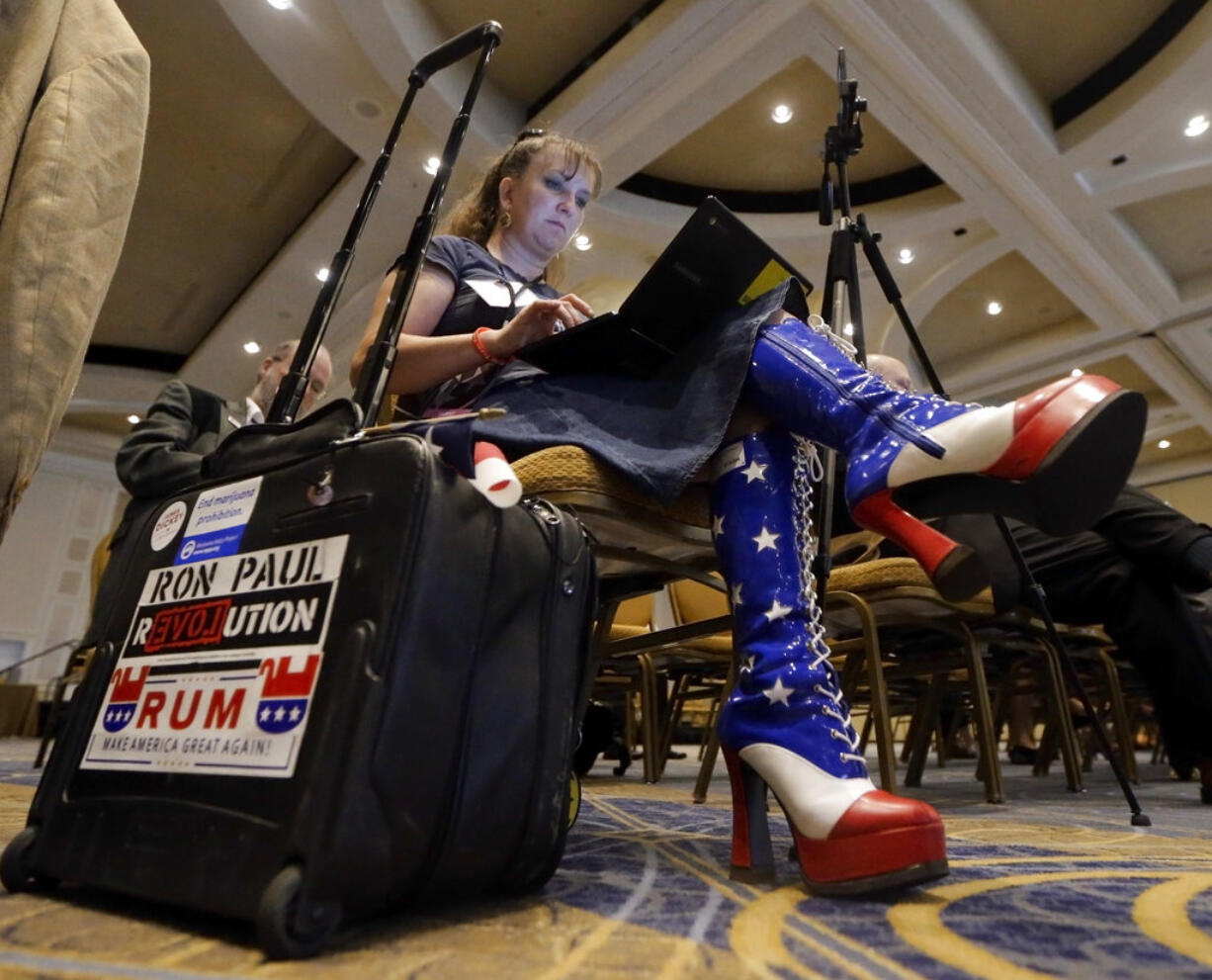 Amy Hedtke of Waxahachie, Texas, takes notes as she listens during a session of the the standing committee on rules at the Republican National Committee summer meeting, Thursday, Aug. 24, 2017, in Nashville, Tenn.