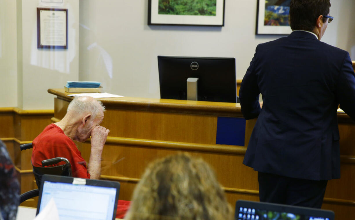 Charles Emery, left, wipes his eye as he sits in a wheelchair as he appears for an arraignment hearing, Thursday, Aug. 31, 2017, in Seattle. Emery is one of three elderly brothers facing child pornography charges after their arrest earlier in the month. (AP Photo/Ted S.